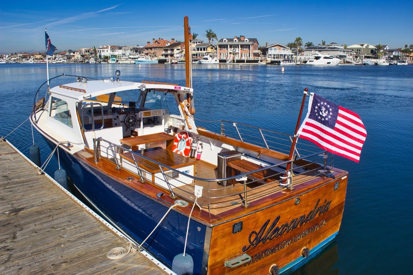The Alexandria, a restored classic wood boat, at her dock in Huntington Harbour