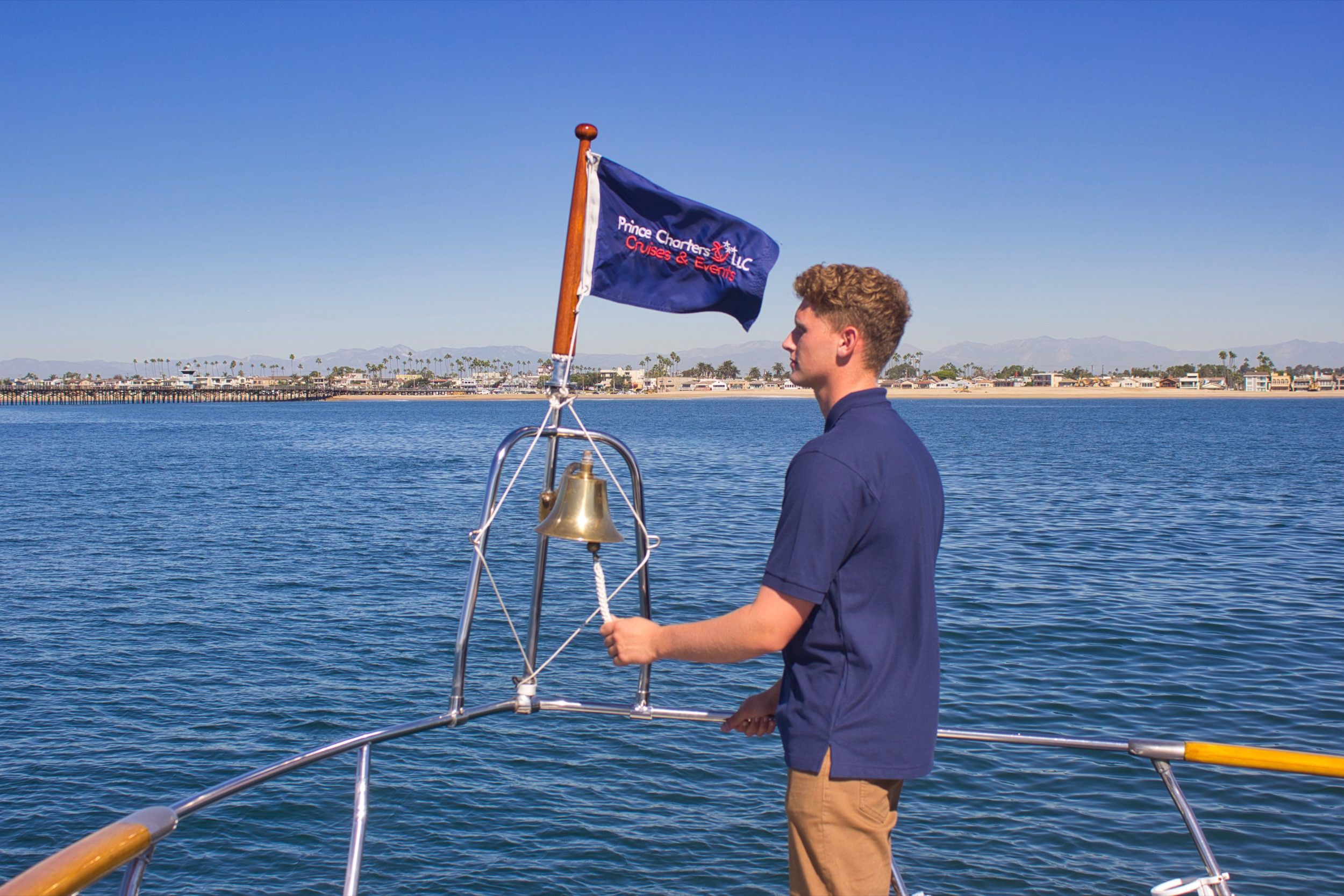 The captain ringing the ship's bell at the bow